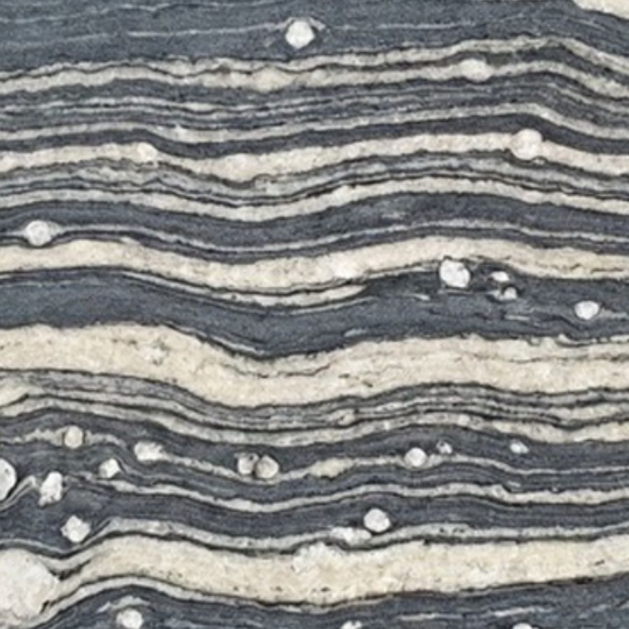 Schist — layered grey and white strata in wave-like bands